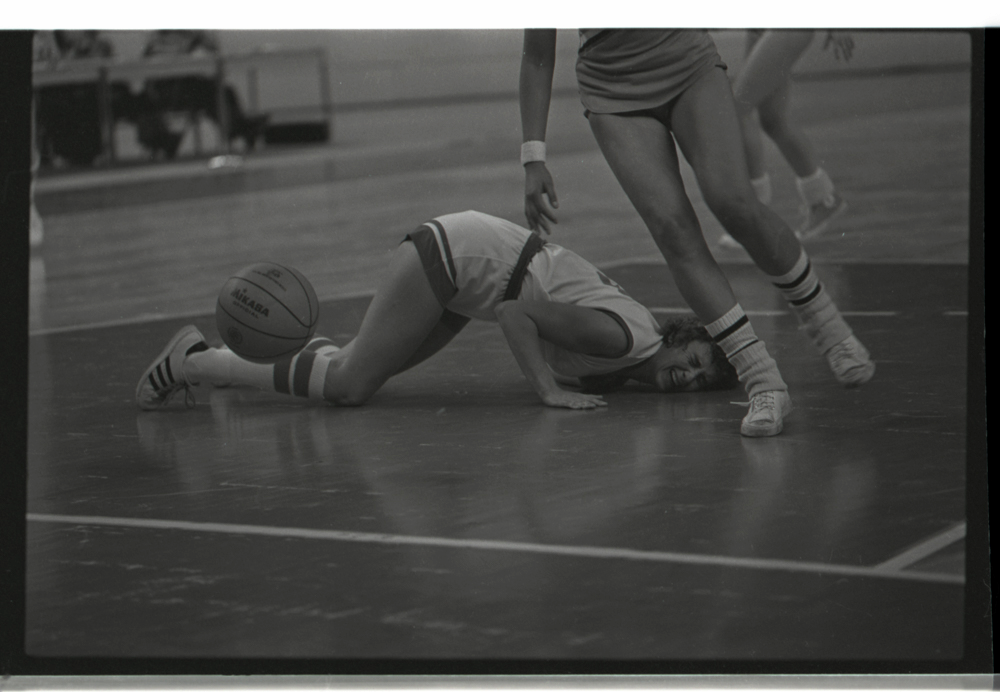 Baloncesto femenino. Panamericanos, México 76 o Puerto Rico 79. Esta imagen, nos señala una vez más el interés de Caicedo por buscar composiciones fotográficas en las que se nos devele un momento único, particular, decisivo, que pueda encapsular y dar sentido a toda la imagen. En este caso, el dolor, el esfuerzo, la dificultad y demanda física del baloncesto son hábilmente capturados en un gesto en el que se nos invita a leer a través de un instante particular toda la mística del deporte.